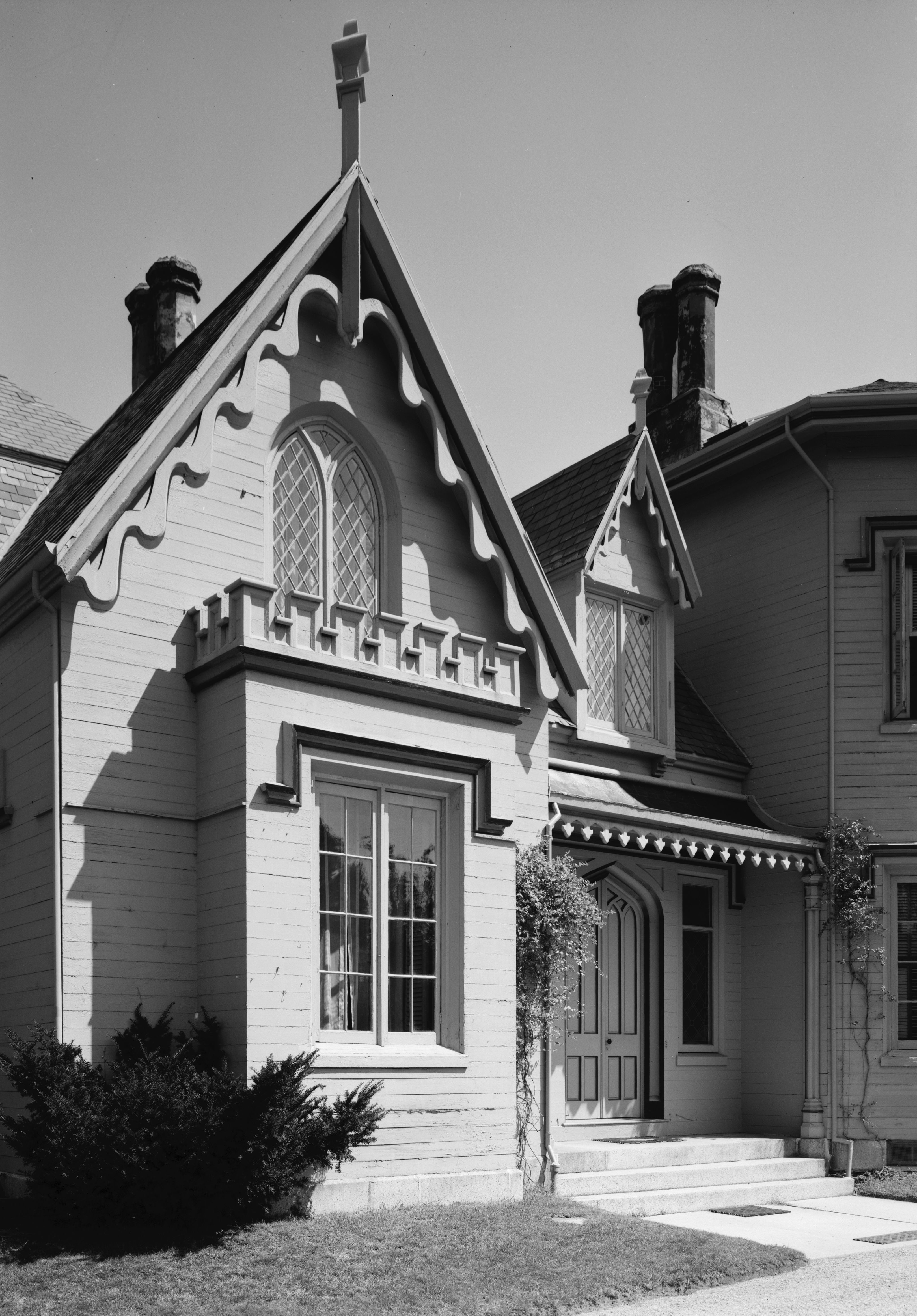 Close-up of a Victorian home showcasing ornate gable, stained glass windows, and detailed trim.
