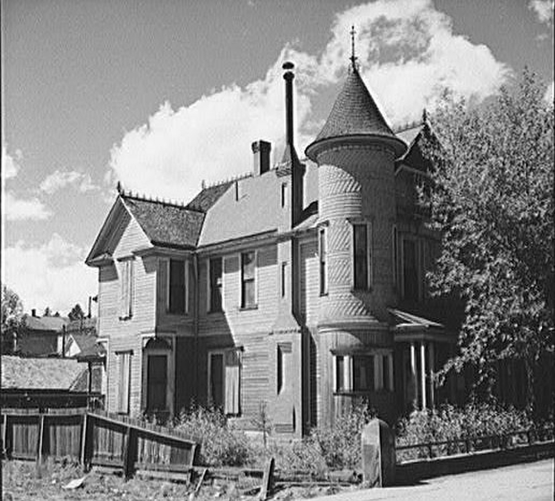 Victorian home showcasing a turret, gabled roof, and decorative woodwork.