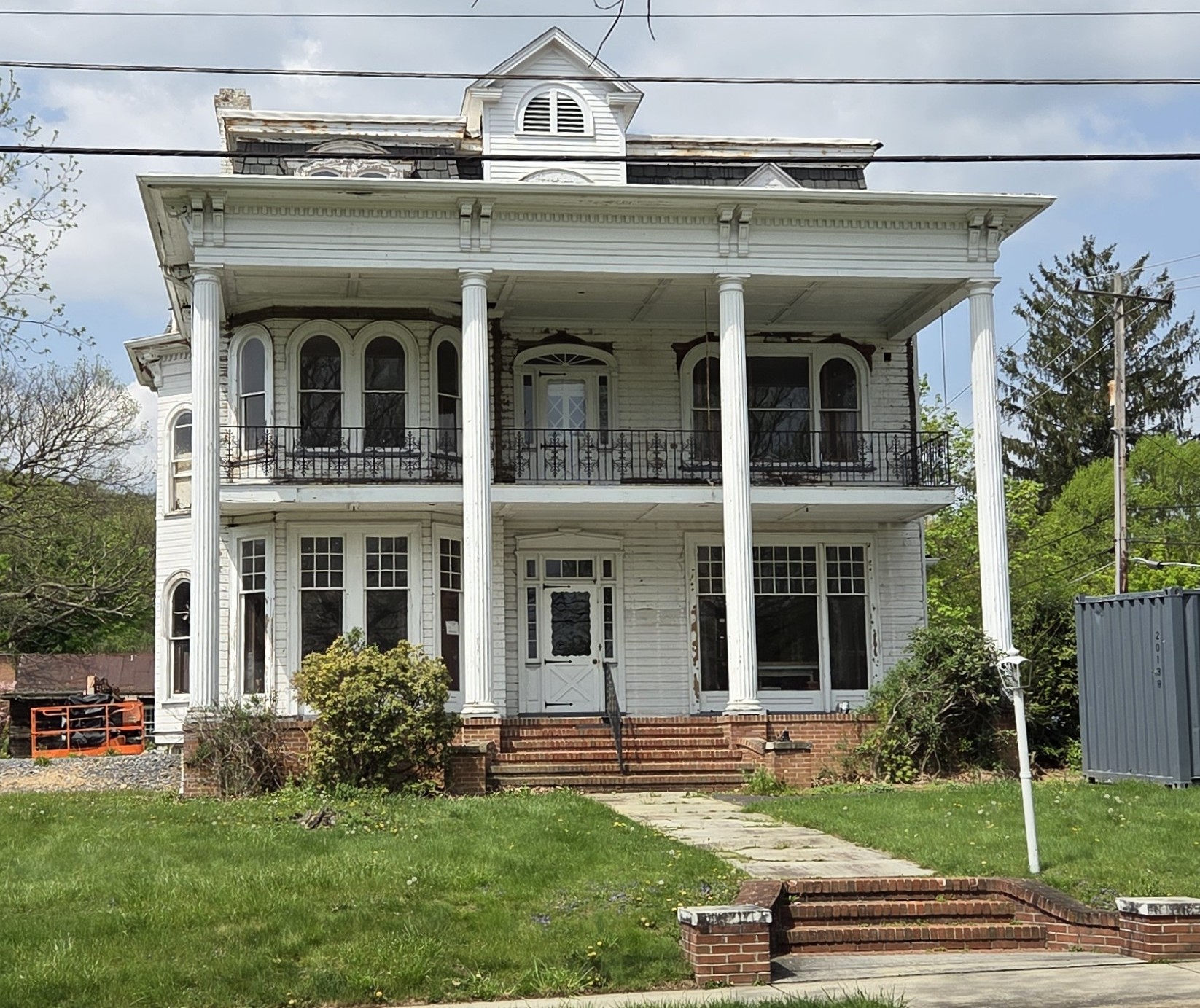 Front view of a Victorian home with a wrap-around porch and decorative windows.