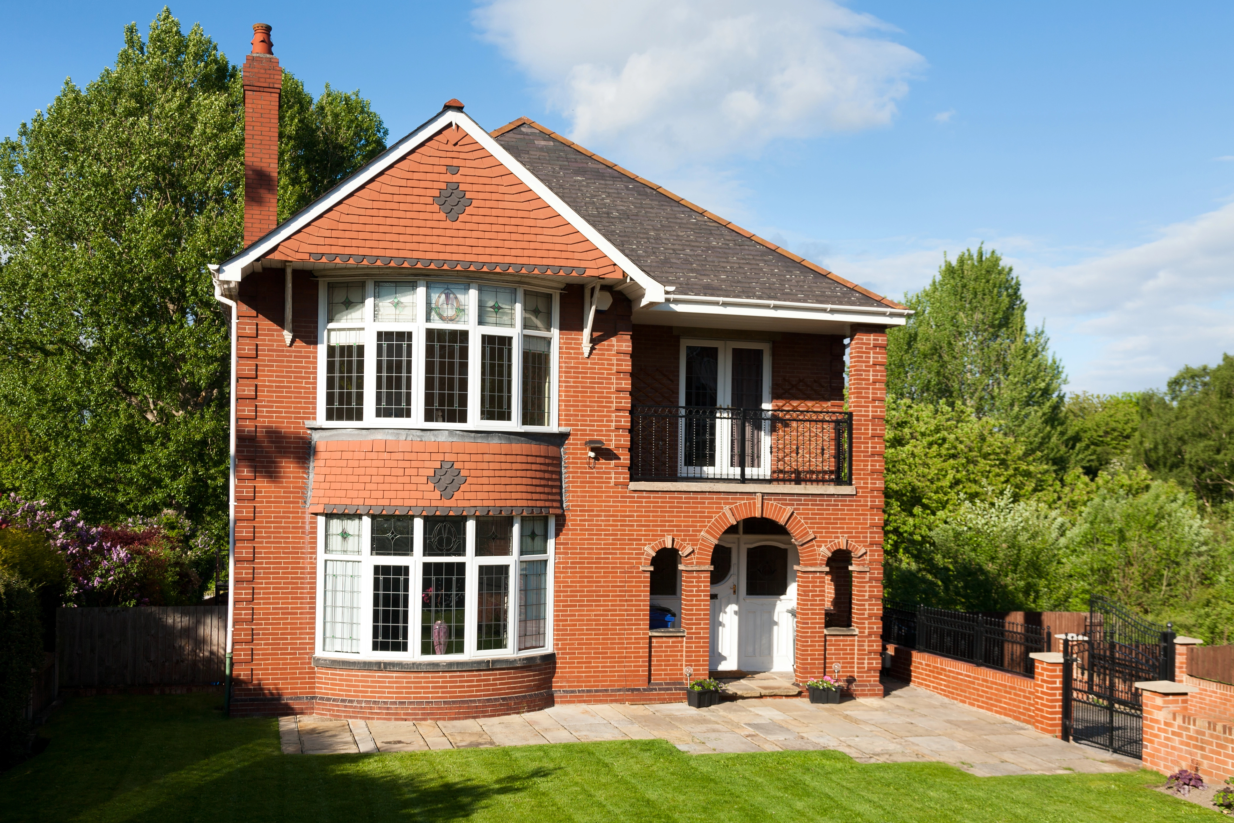 Victorian-style home with bay windows and decorative brickwork