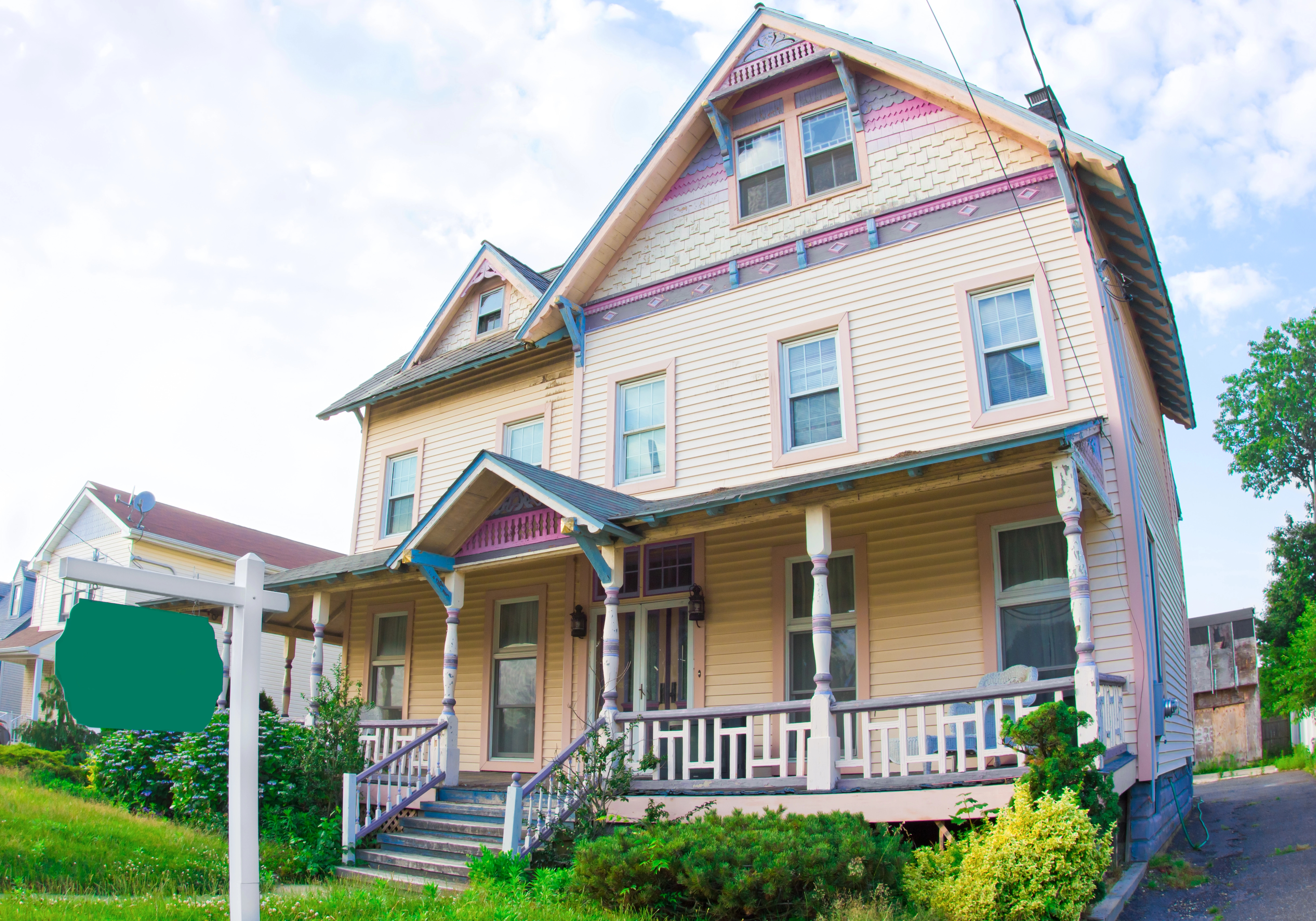 Victorian-style house with ornate trim and a wrap-around porch