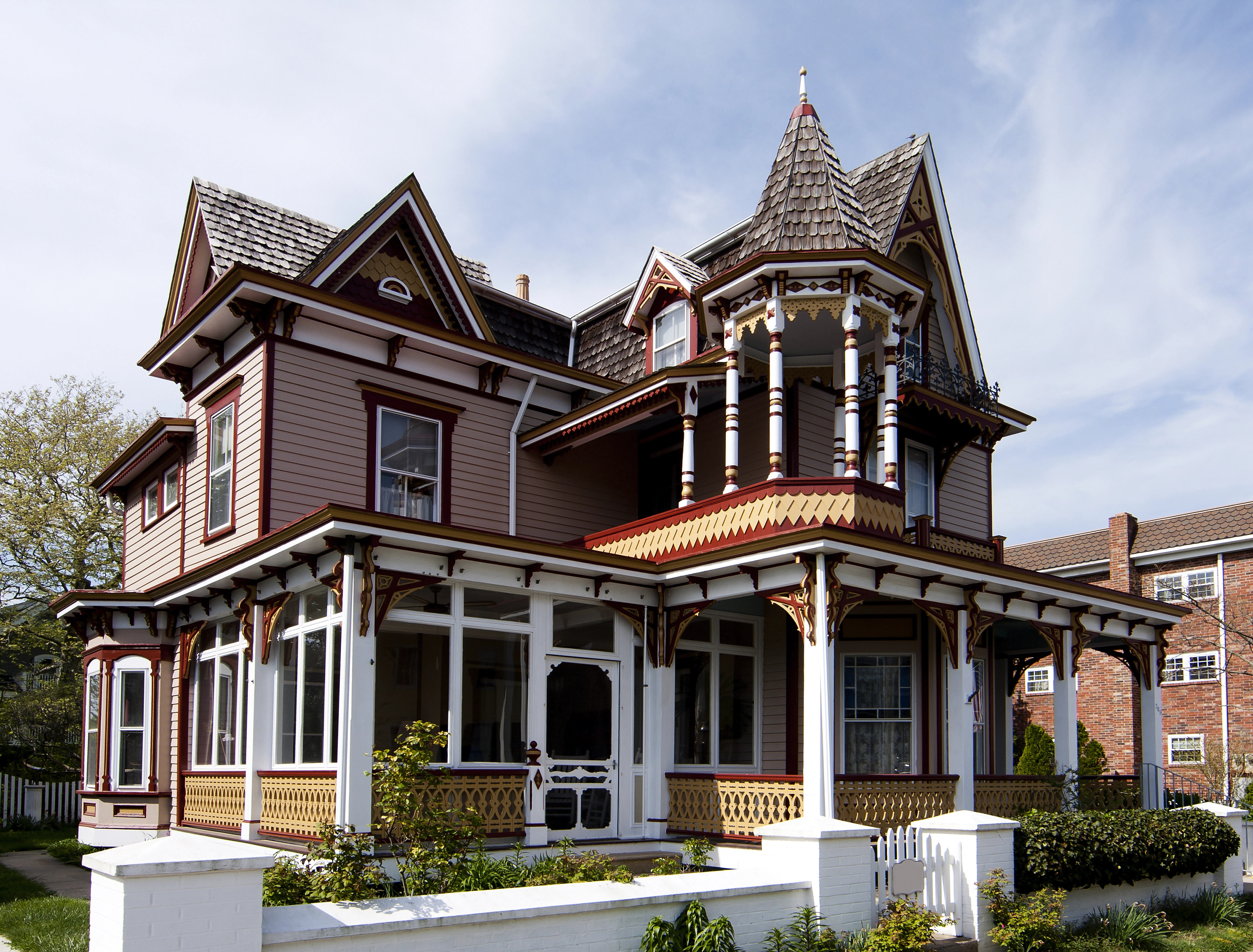 Victorian home with turret, wrap-around porch, and ornate trim