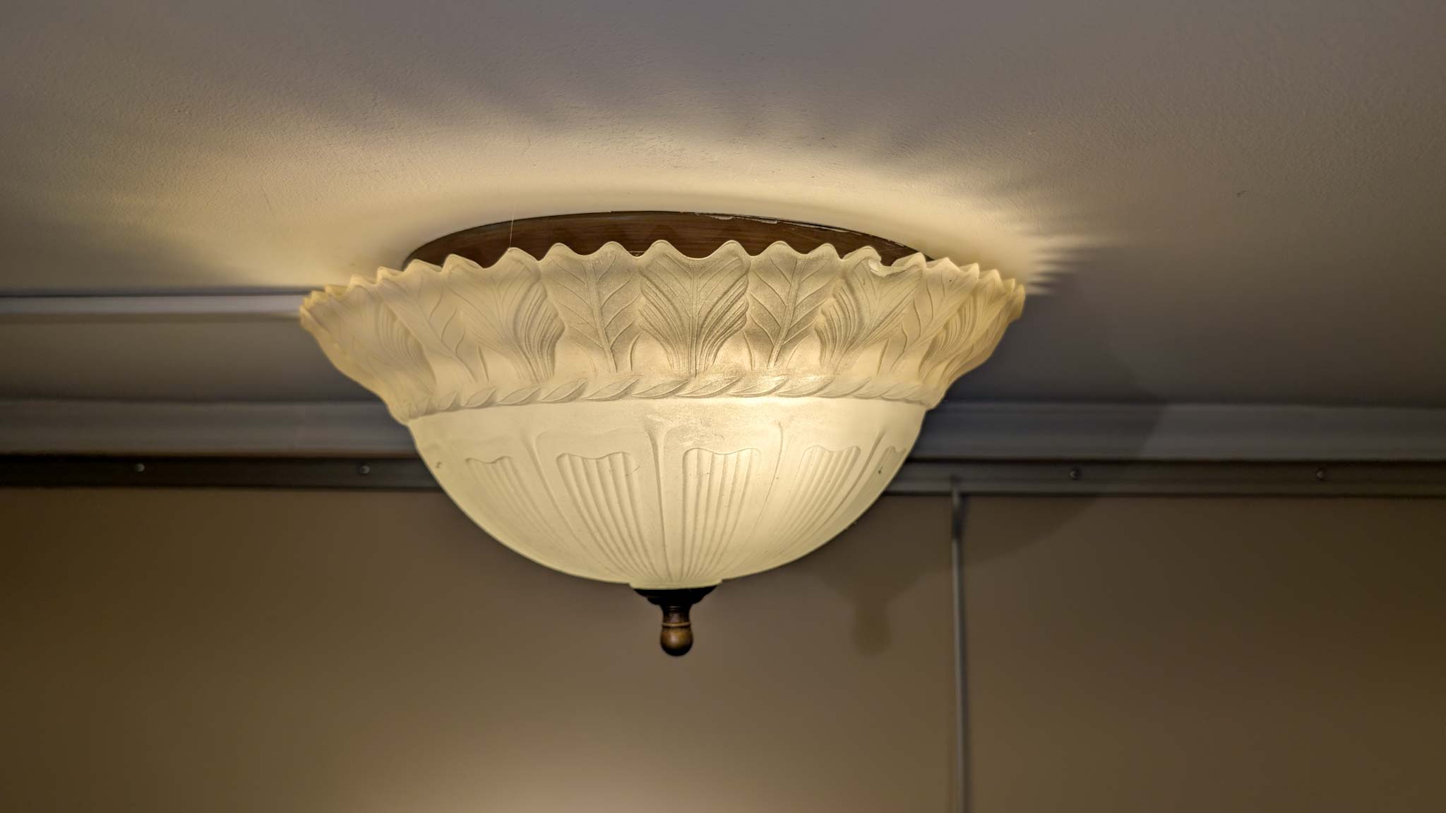 Antique frosted-glass flush-mount ceiling light with a molded wheat-and-fluting pattern.