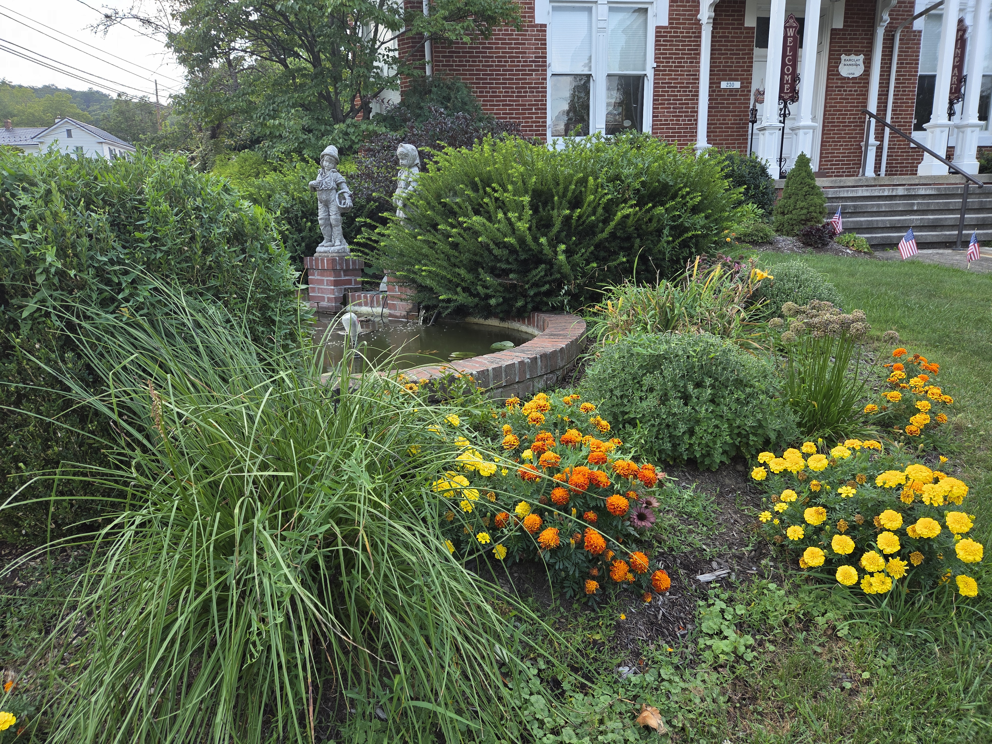 Victorian garden with colorful flowers and stone statues