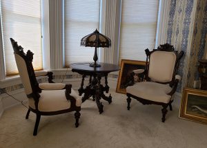 Restored Victorian drawing room parlor with period furniture and art